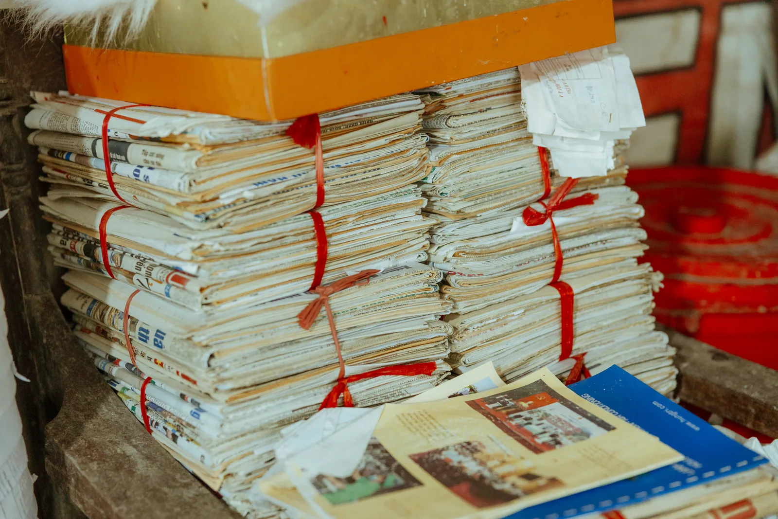 Bundles of newspapers bound together, showcasing vintage reading material. How to verify a famous quote with U.S. newspaper archives and primary records