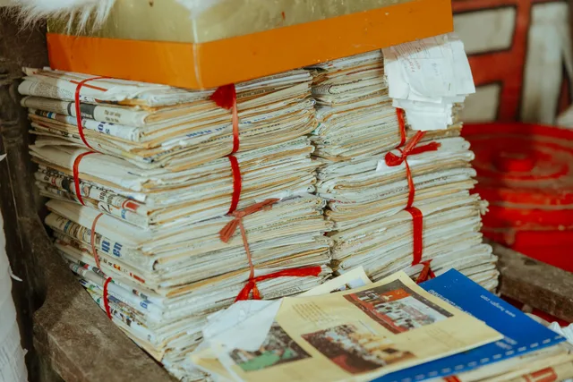 Bundles of newspapers bound together, showcasing vintage reading material. How to verify a famous quote with U.S. newspaper archives and primary records